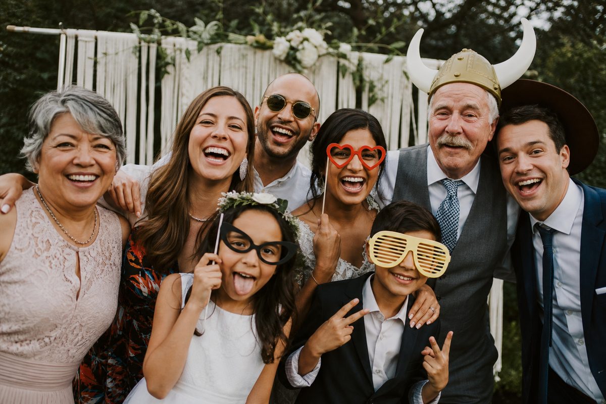 Guests crowding into an open-air photo booth at a reception
