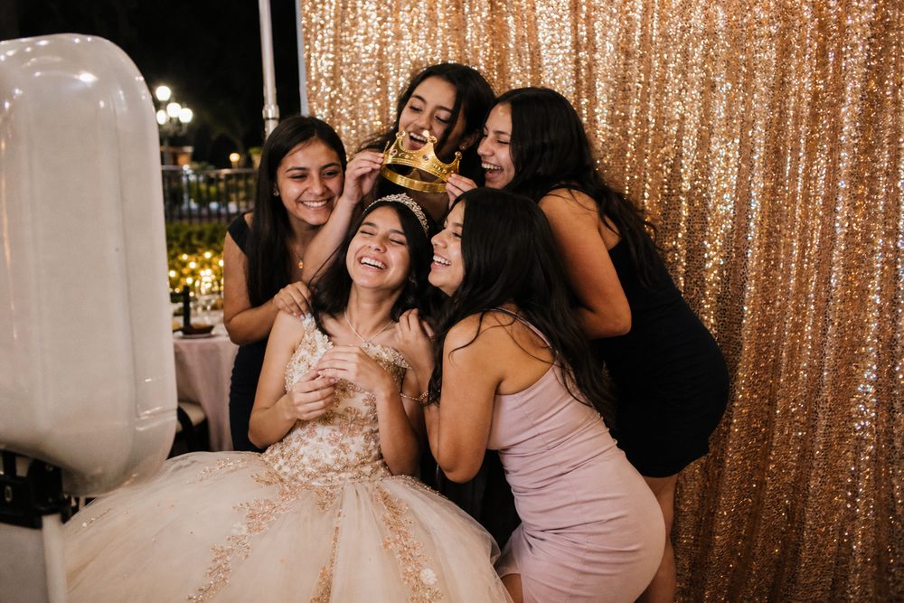 Group of party guests laughing in a photo booth frame